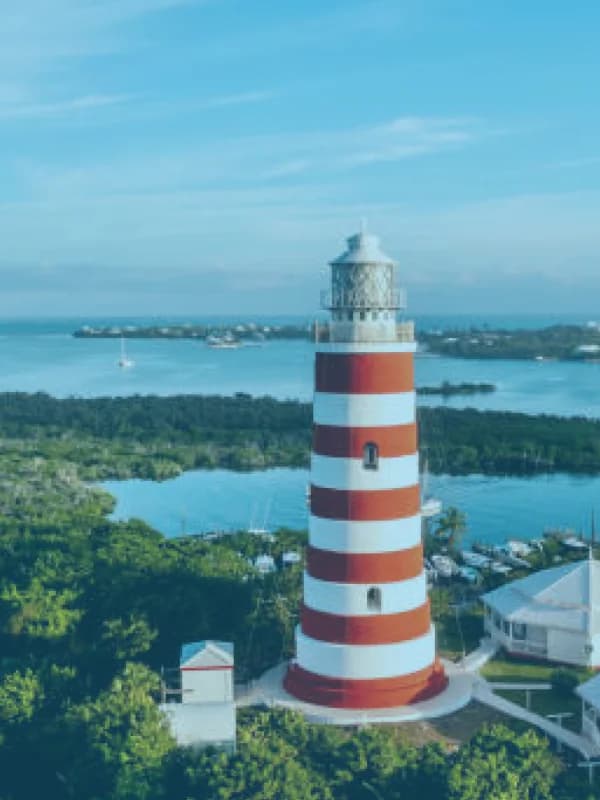 The red-and-white striped lighthouse at Hope Town, Abaco, above the harbour